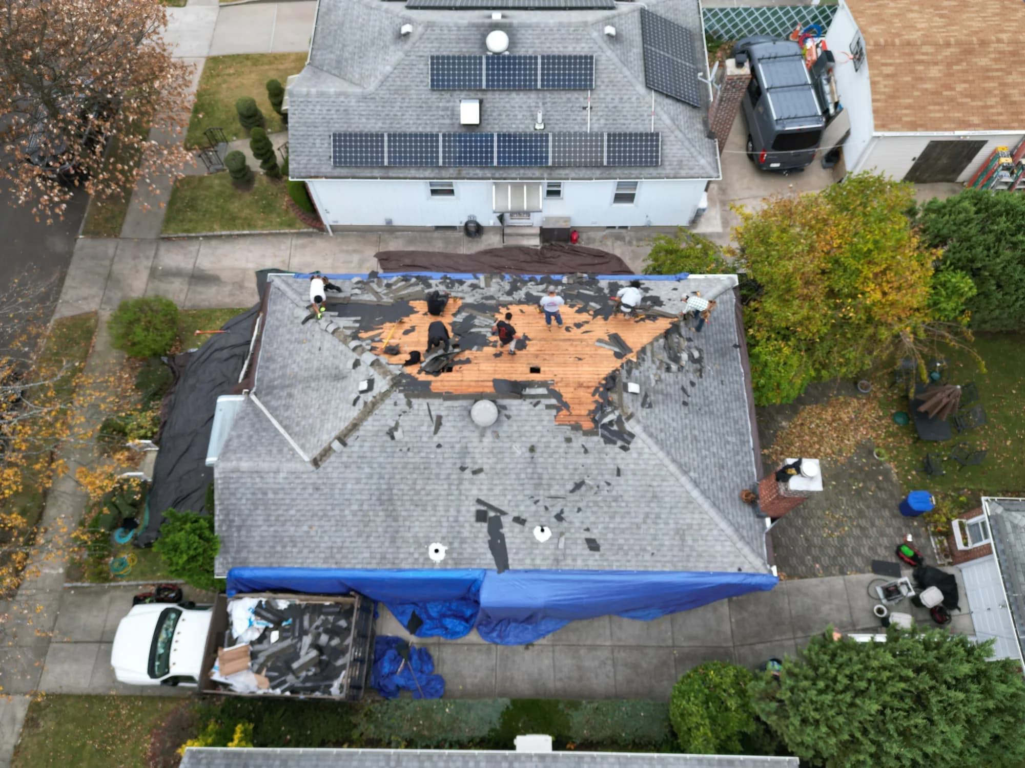 Lucky Stars Roofing crew performing shingle roofing on a home in the Queens and Long Island area