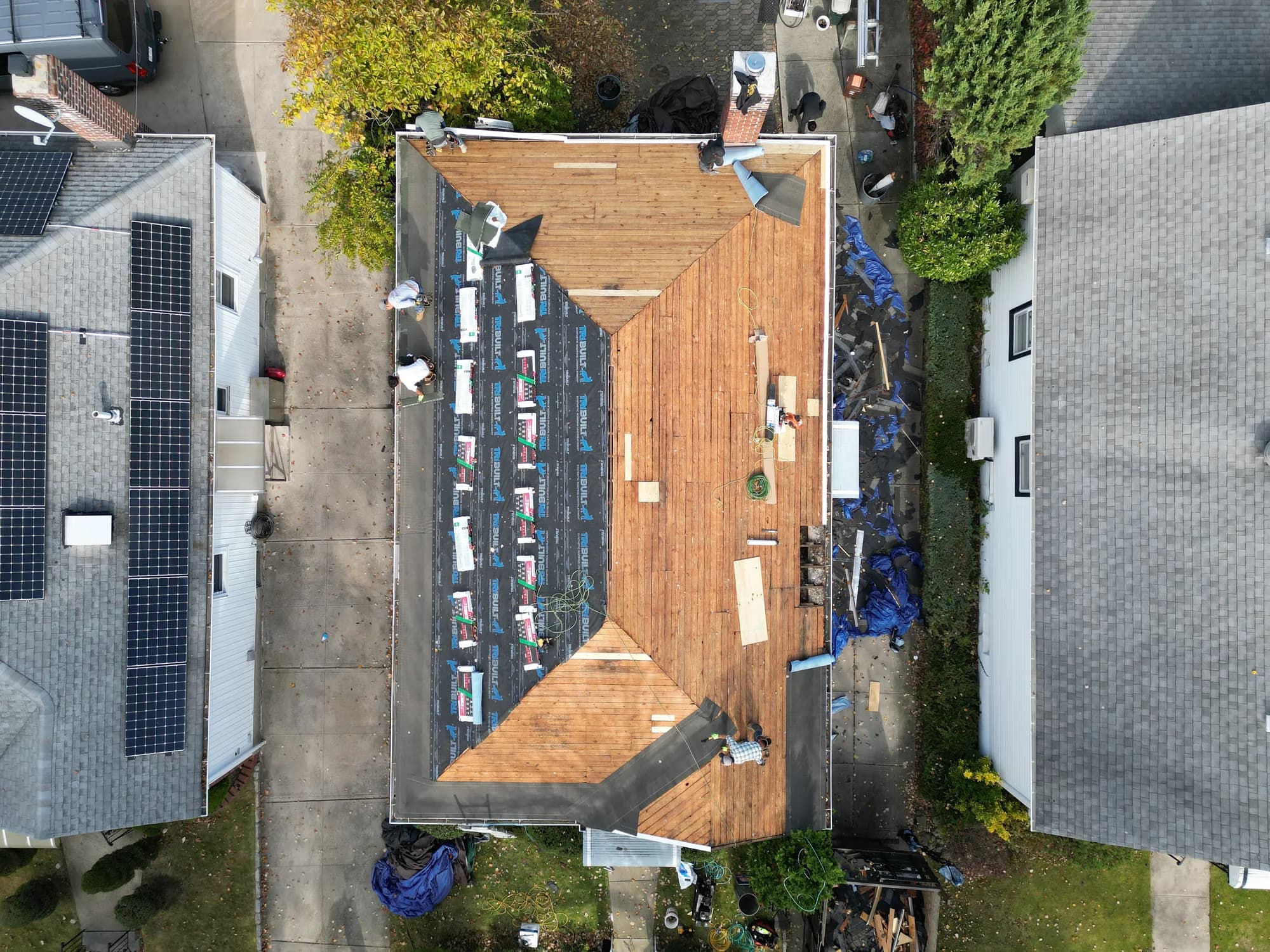 Aerial view of a completed Lucky Stars Roofing job on a single-family home in Queens, NY